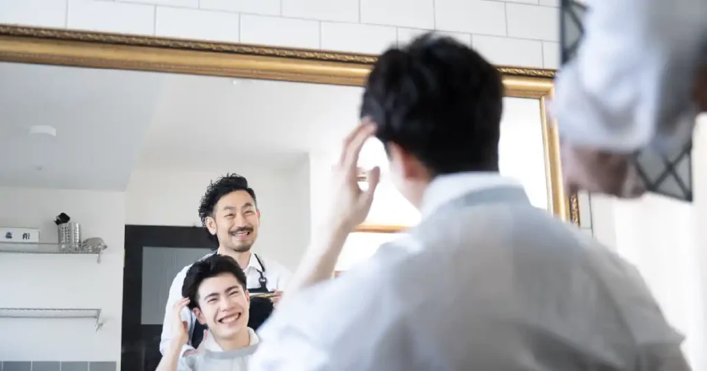 美容師が男性の髪をセットしている様子 - 面接に適した髪型を整えているシーン